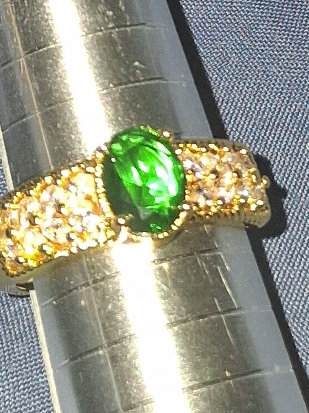 Gold-Tone Ring with Emerald Green Center Stone and is Adjusable 5-9